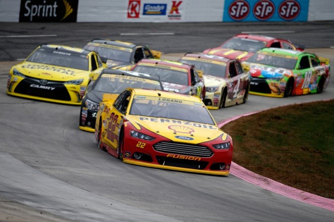 MARTINSVILLE, VA - NOVEMBER 01: Joey Logano, driver of the #22 Shell Pennzoil Ford, leads a pack of cars during the NASCAR Sprint Cup Series Goody's Headache Relief Shot 500 at Martinsville Speedway on November 1, 2015 in Martinsville, Virginia. (Photo by Todd Warshaw/NASCAR via Getty Images)