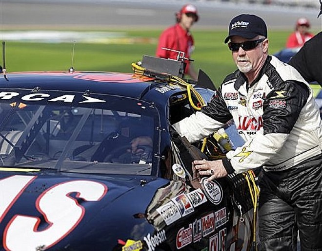 Bobby Gerhart helps his crew push his car along pit road before his qualifying run for the ARCA Series auto race at Daytona International Speedway, Friday, Feb. 15, 2013, in Daytona Beach, Fla. (AP Photo/John Raoux)