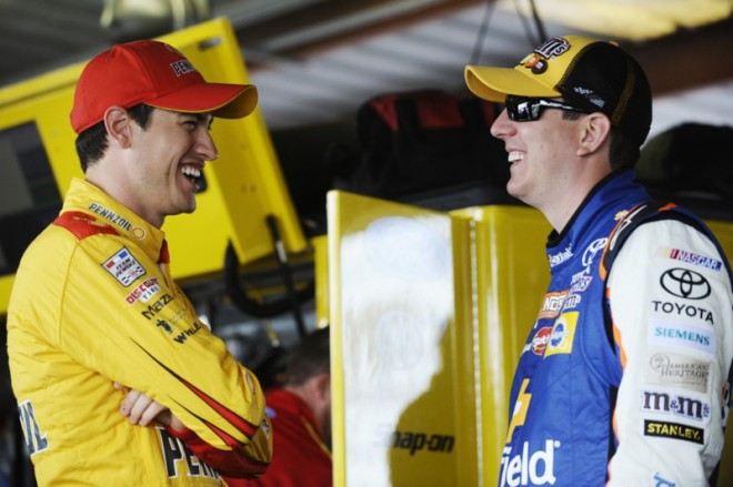 RICHMOND, VA - APRIL 22:  (L-R) Joey Logano, driver of the #22 Shell Pennzoil Ford, and Kyle Busch, driver of the #18 Banfield Toyota, talk in the garage area during practice for the NASCAR Sprint Cup Series TOYOTA OWNERS 400 at Richmond International Raceway on April 22, 2016 in Richmond, Virginia.  (Photo by Rainier Ehrhardt/Getty Images)