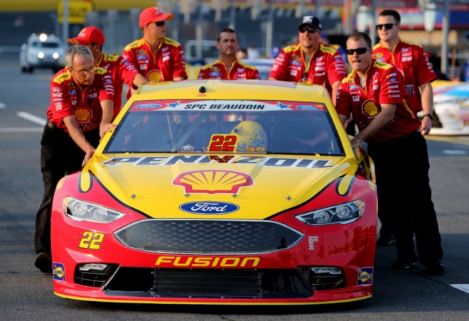 CHARLOTTE, NC - MAY 26: Team members push the #22 Shell Pennzoil Ford, driven by Joey Logano(not pictured), through the garage area during qualifying for the NASCAR Sprint Cup Series Coca-Cola 600 at Charlotte Motor Speedway on May 27, 2016 in Charlotte, North Carolina. (Photo by Jerry Markland/NASCAR via Getty Images)