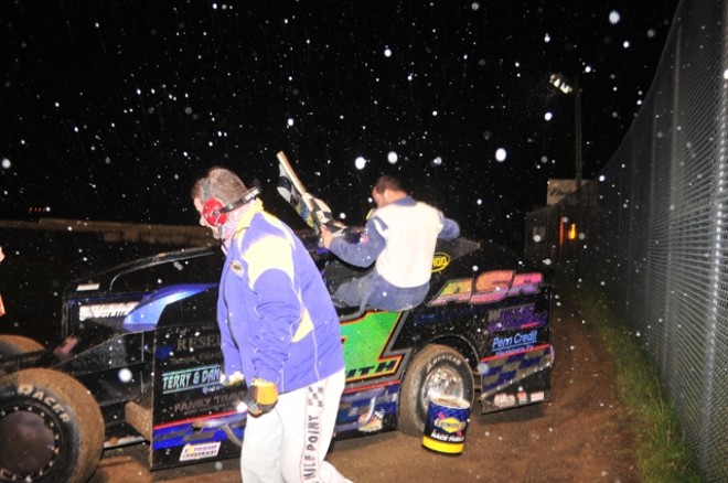 snow falls as Andrew Smith exits his car in Victory Lane