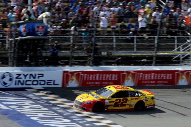 BROOKLYN, MI - JUNE 12:  Joey Logano, driver of the #22 Shell Pennzoil Ford, takes the checkered flag to win the NASCAR Sprint Cup Series FireKeepers Casino 400 at Michigan International Speedway on June 12, 2016 in Brooklyn, Michigan.  (Photo by Jerry Markland/Getty Images )