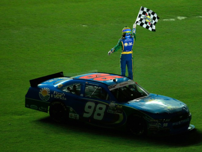 DAYTONA BEACH, FL - JULY 01: Aric Almirola, driver of the #98 Fresh From Florida Ford, celebrates with the checkered flag on the infield after winning the NASCAR XFINITY Series Subway Firecracker 250 at Daytona International Speedway on July 1, 2016 in Daytona Beach, Florida. (Photo by Chris Trotman/Getty Images)