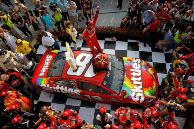 INDIANAPOLIS, IN - JULY 24:  Kyle Busch, driver of the #18 Skittles Toyota, celebrates in victory lane after winning the NASCAR Sprint Cup Series Crown Royal Presents the Combat Wounded Coalition 400 at Indianapolis Motor Speedway on July 24, 2016 in Indianapolis, Indiana.  (Photo by Brian Lawdermilk/Getty Images)