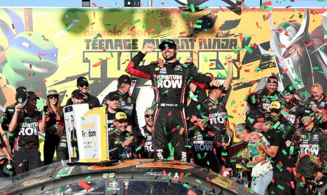 JOLIET, IL - SEPTEMBER 18:  Martin Truex Jr, driver of the #78 Furniture Row/Denver Mattress Toyota, celebrates in Victory Lane after winning the NASCAR Sprint Cup Series Teenage Mutant Ninja Turtles 400 at Chicagoland Speedway on September 18, 2016 in Joliet, Illinois.  (Photo by Kena Krutsinger/Getty Images)