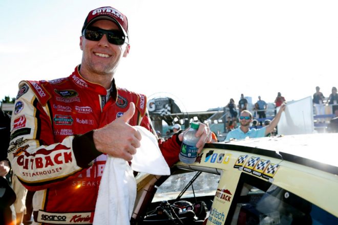 KANSAS CITY, KS - OCTOBER 16:  Kevin Harvick, driver of the #4 Outback Chevrolet, poses with the winner's decal after winning the NASCAR Sprint Cup Series Hollywood Casino 400 at Kansas Speedway on October 16, 2016 in Kansas City, Kansas.  (Photo by Brian Lawdermilk/NASCAR via Getty Images)