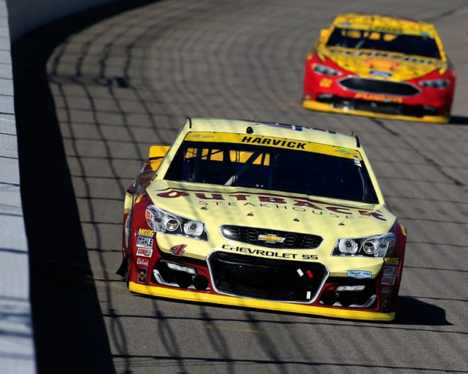 KANSAS CITY, KS - OCTOBER 16:  Kevin Harvick, driver of the #4 Outback Chevrolet, leads Joey Logano, driver of the #22 Shell Pennzoil Ford, and Denny Hamlin, driver of the #11 FedEx Express Toyota, during the NASCAR Sprint Cup Series Hollywood Casino 400 at Kansas Speedway on October 16, 2016 in Kansas City, Kansas.  (Photo by Chris Trotman/Getty Images)