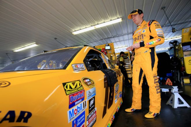LONG POND, PA - JULY 29: Kyle Busch, driver of the #18 M&M's 75th Anniversary Toyota, stands in the garage area during practice for the NASCAR Sprint Cup Series Pennsylvania 400 at Pocono Raceway on July 29, 2016 in Long Pond, Pennsylvania. (Photo by Chris Trotman/Getty Images)
